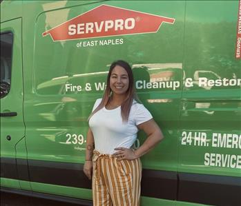 Tayler, female employee posing in front of a SERVPRO van