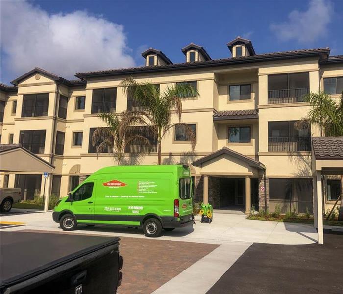 apartment complex and servpro truck out front