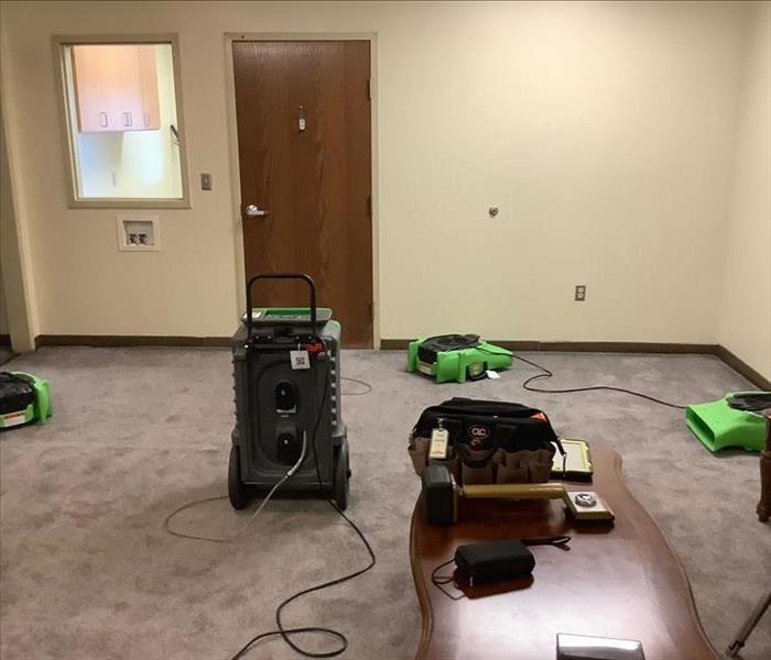 Three Air Movers and a Dehumidifier Drying a Water Loss