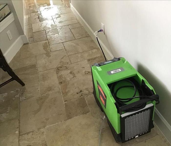 Hallway with sewage water and SERVPRO equipment